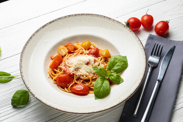 delicious pasta in a plate on a white wooden table. close-up
