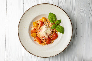 delicious pasta in a plate on a white wooden table. close-up
