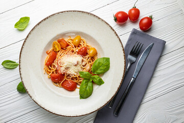 delicious pasta in a plate on a white wooden table. close-up
