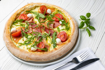 delicious pizza on a white wooden table. close-up
