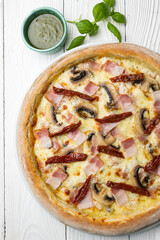 delicious pizza on a white wooden table. close-up
