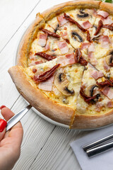 delicious pizza on a white wooden table. close-up
