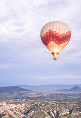 Process of launching many colored beautiful balloons into air in Cappadocia in mountains early at dawn. Filling balloon with hot air from burner, preparing basket. Excursion,flight for tourists above