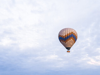 Process of launching many colored beautiful balloons into air in Cappadocia in mountains early at dawn. Filling balloon with hot air from burner, preparing basket. Excursion,flight for tourists above