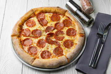 delicious pizza on a white wooden table. close-up
