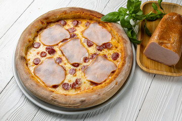 delicious pizza on a white wooden table. close-up
