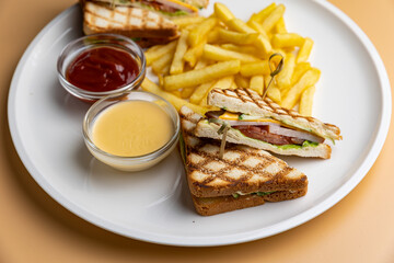 A plate of food with a sandwich and french fries.
