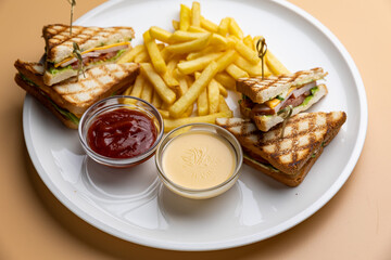 A plate of food with a sandwich and french fries.
