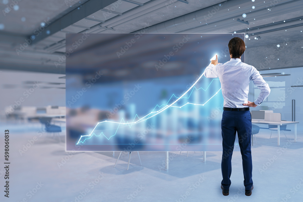 Poster back view of young businessman using abstract growing business chart hologram on blurry office inter