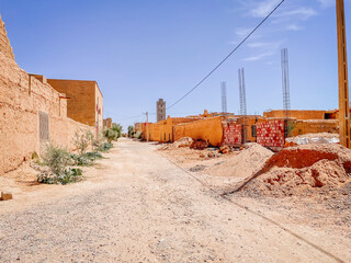 Empty street in Morocco, mud houses, and sandy road