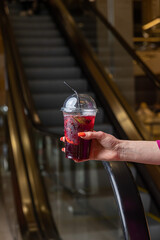 A cup of fruit juice with a lid on it