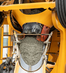 Wet Cement coming down a cement truck chute at a construction site