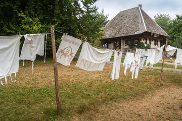 Hanging clothes in front of a traditional farmhouse at Black Forest Open Air Museum in Gutach,...