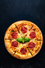 Circle pepperoni pizza with mozzarella cheese on wooden table
