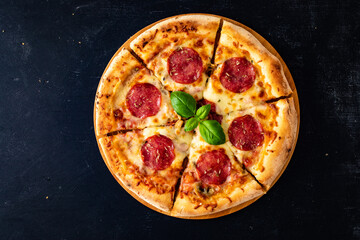 Circle pepperoni pizza with mozzarella cheese on wooden table
