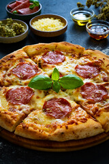 Circle pepperoni pizza with mozzarella cheese on wooden table
