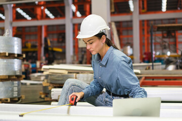 The project manager and engineers are inspecting workpieces and checking standards and safety for products and safety in the factory. Technician and Female Worker Talking on a Meeting in a Factory.