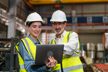 The project manager and engineers are inspecting workpieces and checking standards and safety for products and safety in the factory. Technician and Female Worker Talking on a Meeting in a Factory.