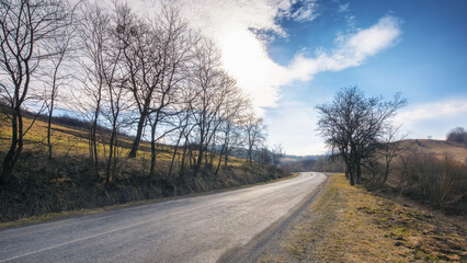 early days of spring bring a new life to the countryside, as the road winds through the lush valley