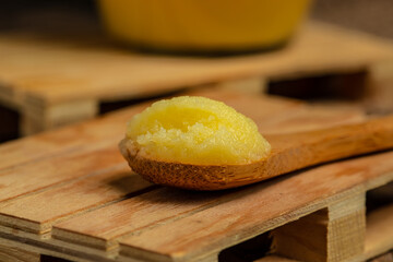 ghee oil. Ghee or clarified butter in jar on a wooden background. banner, menu, recipe place for text