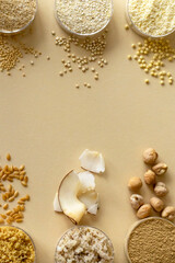 Mixed, gluten-free flour set on beige background with cereals, seeds and nuts