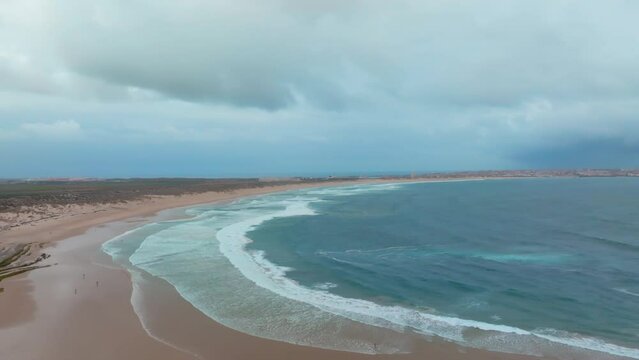 Incredible Aerial View of Endless Beach with Massive Waves Breaking in the Distance on an Overcast Day