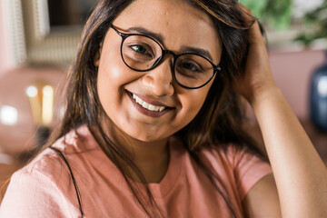 Close up portrait smart confident smiling millennial indian woman. Attractive young hindu teenager student girl freelancer looking at camera, posing for photo.