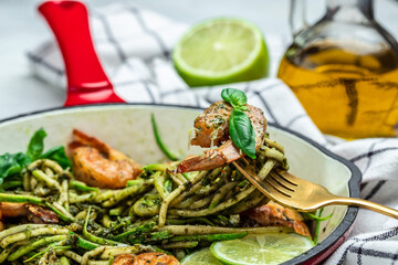 zucchini spaghetti Pasta with basil pesto sauce and grilled shrimp, Vegetarian healthy food, place for text, top view