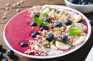 Blueberry Smoothie Bowl with Granola, Banana, and Chia Seeds, Healthy Food, Vegan or Vegetarian Diet Food Concept