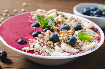 Blueberry Smoothie Bowl with Granola, Banana, and Chia Seeds, Healthy Food, Vegan or Vegetarian Diet Food Concept