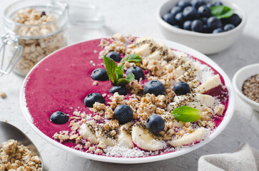 Blueberry Smoothie Bowl with Granola, Banana, and Chia Seeds, Healthy Food, Vegan or Vegetarian Diet Food Concept