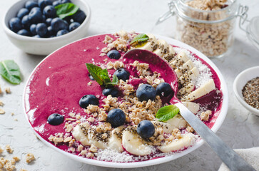 Blueberry Smoothie Bowl with Granola, Banana, and Chia Seeds, Healthy Food, Vegan or Vegetarian Diet Food Concept