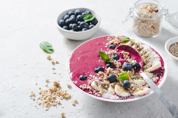 Blueberry Smoothie Bowl with Granola, Banana, and Chia Seeds, Healthy Food, Vegan or Vegetarian Diet Food Concept