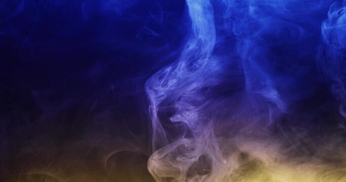 Colored smoke moves beautifully against a black background. Mockup for your logo. Wide angle horizontal wallpaper or web banner. Slow motion.