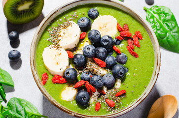 Healthy Green Spinach Smoothie in a Bowl with Banana, Blueberry, Goji, and Chia Seed Toppings, Detox, Vegetarian Food
