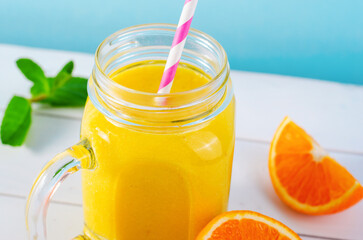Orange Smoothie in a Jar, Vitamin Drink or Cocktail on Bright Background
