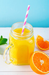 Orange Smoothie in a Jar, Vitamin Drink or Cocktail on Bright Background