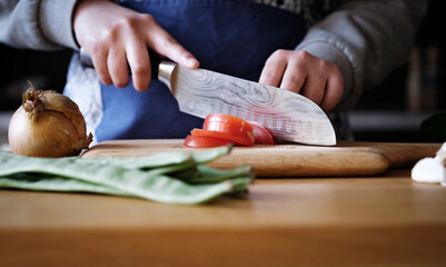 close up of a woman chef cutting tomatoes