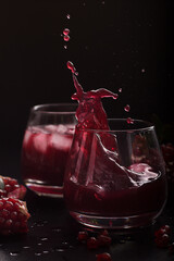 Drink splashes in a glass. Pomegranate cocktail close up