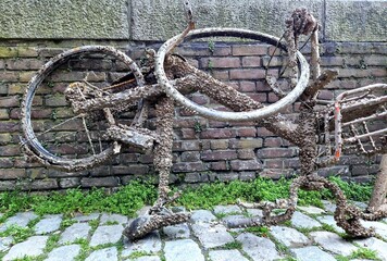 


Weathered bicycle that has been submerged in river Meuse for a long time, with barnacles growing on the rusty metal - Rotterdam, the Netherlands, Europe, where cycling is part of local culture