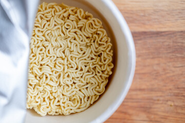 instant noodles, on a wooden background, top view