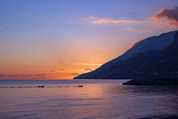Maiori, Italy. Sunset view of the Amalfi Coast, from Maiori, while two boats are returning to the bay. 2022-12-28.