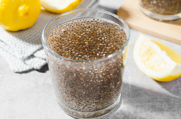 Chia Infused Water with Lemon, Healthy Citrus Drink on Bright Background