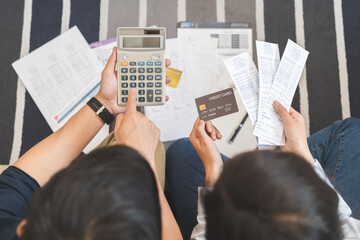 Stressed financial owe asian young couple love sitting stressed and confused hand calculate expense from credit card, invoice no money to pay, mortgage or loan. Debt, bankrupt or bankruptcy people.