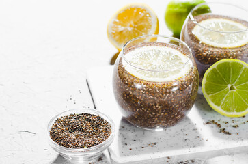 Chia Infused Water with Lemon, Healthy Citrus Drink on Bright Background
