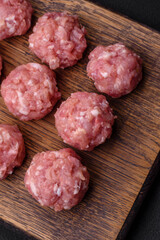 Raw meatballs of minced meat beef, pork or chicken with salt, spices and herbs