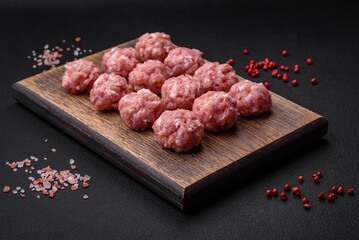 Raw meatballs of minced meat beef, pork or chicken with salt, spices and herbs