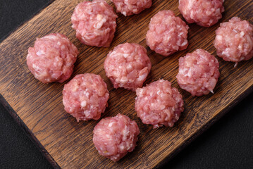 Raw meatballs of minced meat beef, pork or chicken with salt, spices and herbs