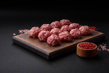 Raw meatballs of minced meat beef, pork or chicken with salt, spices and herbs
