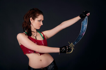 Portrait of amazon girl with a sword, actress in costume. Go go dancer